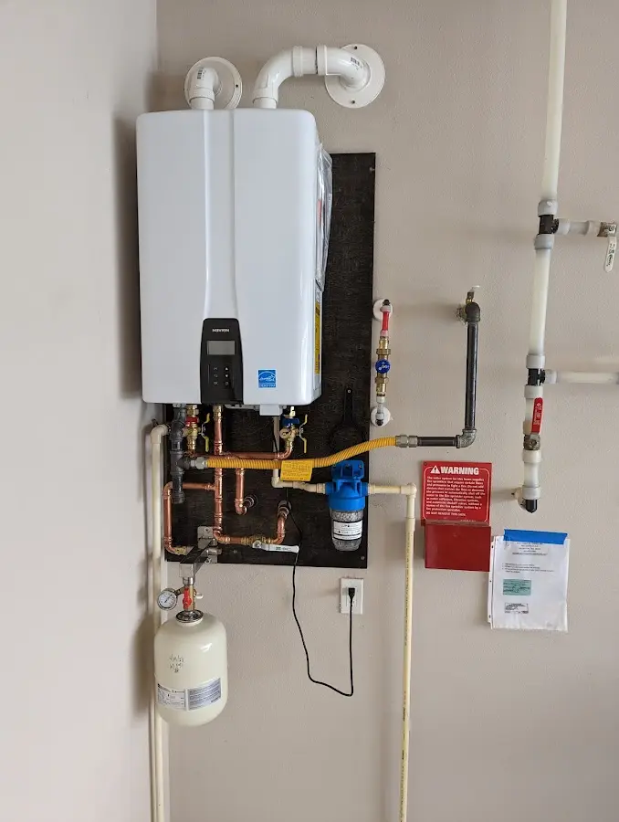 Professional plumber installing copper piping in a Rye home